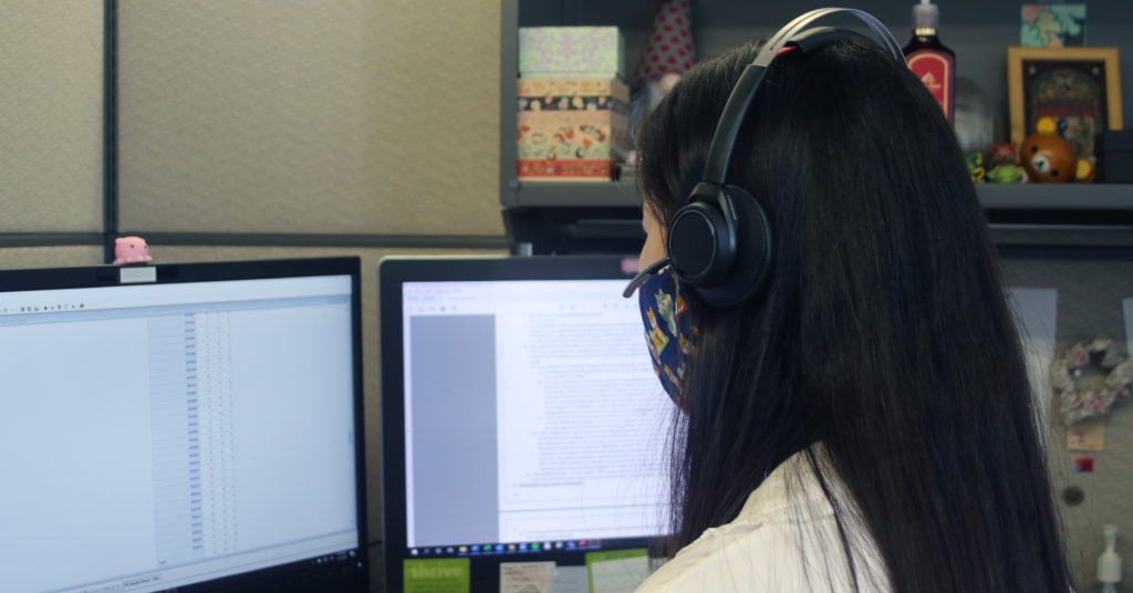Influenza epidemiologist Han Ha at a computer workstation