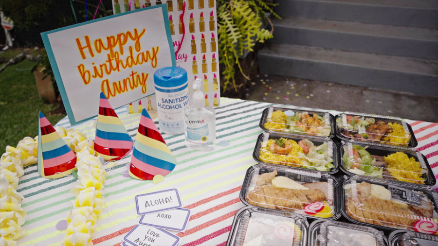 Table with "Happy Birthday Aunty" sign and bentos